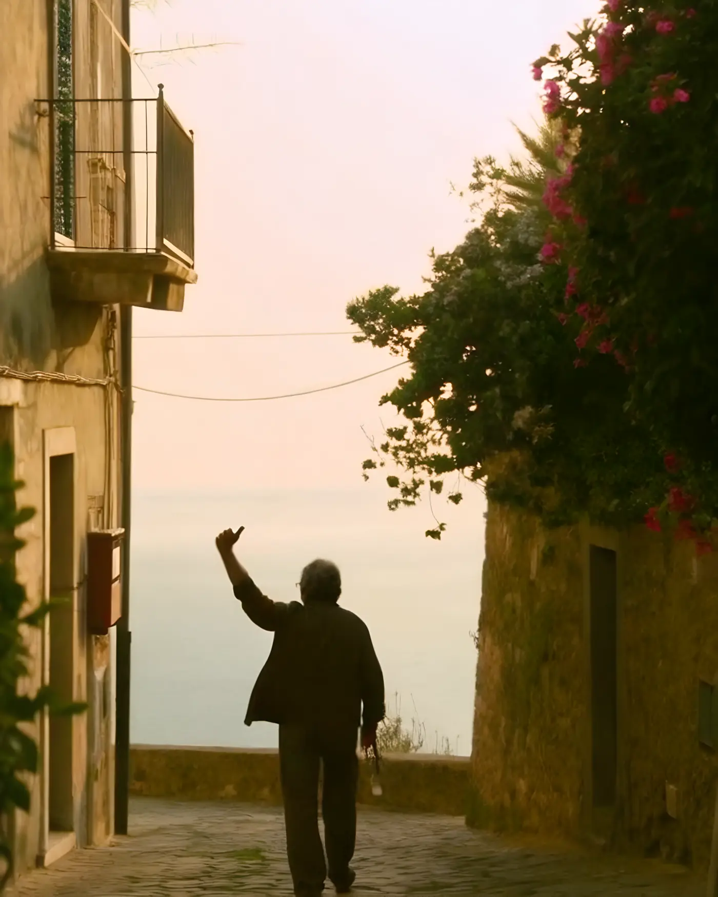 A local walking toward the sea at golden hour