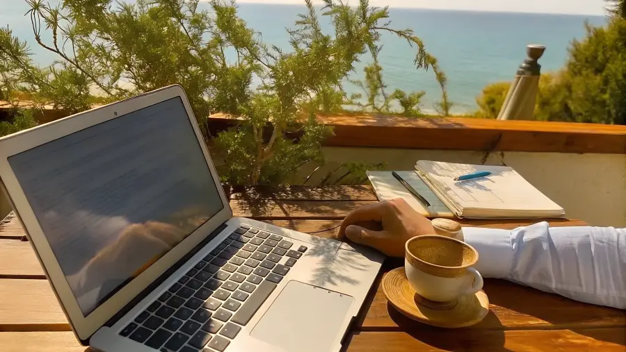 Laptop and espresso on a sea-view terrace